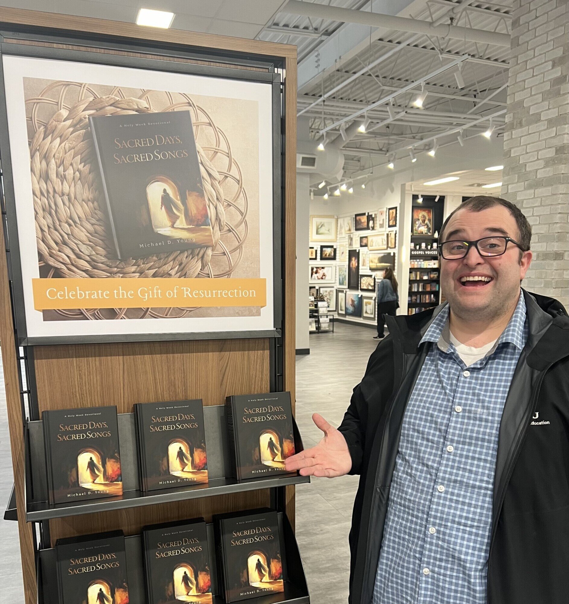 Author Michael D. Young standing in front of a display of his books in a bookstore.